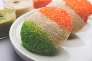 Tiranga Idly or Idli made using Indian National Flag colours like saffron, white and green. Served with colourful chutney. Concept for Happy Independence day greeting card