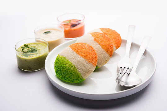 Tiranga Idly or Idli made using Indian National Flag colours like saffron, white and green. Served with colourful chutney. Concept for Happy Independence day greeting card