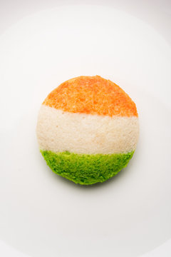 Tiranga Idly or Idli made using Indian National Flag colours like saffron, white and green. Served with colourful chutney. Concept for Happy Independence day greeting card