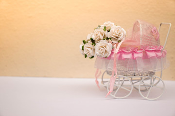 Stroller with white flower .communicated to newborn or infant,blank space,orange flare.