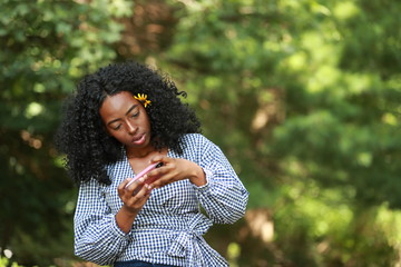 Ethnic woman gaming with smartphone