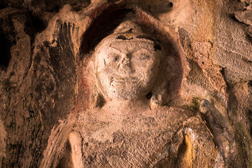 Amazing ancient Buddha statue on the wall of Thailand cave.