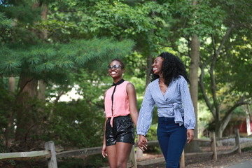 Happy black homosexual women in park