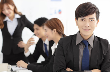 smiling business man  with colleagues on background