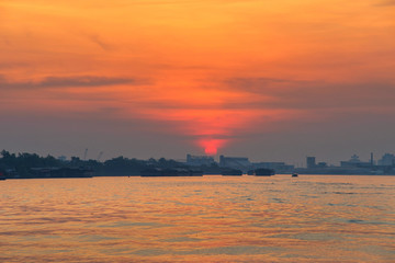 Cargo ship on river at sunrise