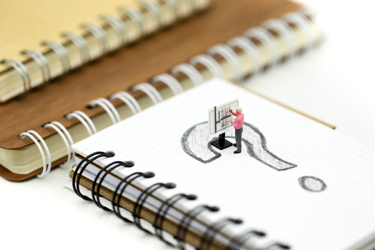 Miniature people : Businessman with THE QUESTION MARK using for concept Punctuation Day