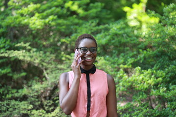 Smiling ethnic woman talking on smartphone