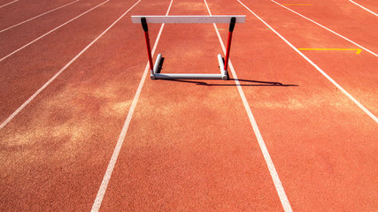 hurdle race barrier on red  running track , athletic stadium