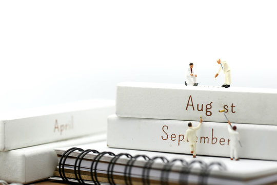 Miniature people: Workers team brush painting block list of month september,Using for concept Calendar Adjustment Day.
