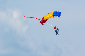 A Parachute with Romanian Flag Color Slowly Descending from the Sky