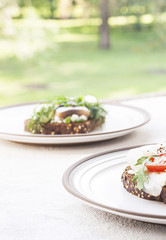 Sandwich with pieces of marinated herring with cream and dill. Selective focus.