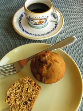 Healthy whole grain pumpkin muffin with cup of Italian espresso