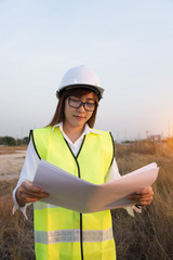 Woman engineer in power plant checking production