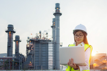 Asia woman engineer working with tablet PC near power plant