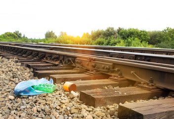 A package with garbage on the railway thrown out from the window of the train by passengers,...