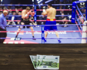 Euro money against the background of the TV on which show boxing, ring