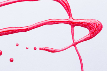 Nail polish on a white background in the form of strips and drops