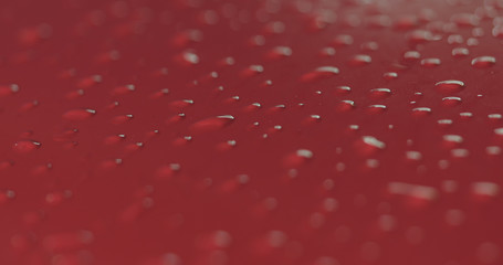 Closeup focus red car wash degreasing paint soak