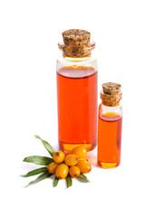 Sea buckthorn and two bottles with sea buckthorn oil isolated on white background