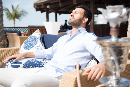 Expat man relaxing at restaurant.