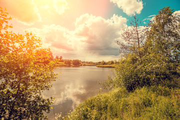 View of the lake with trees on the shore. Wilderness, beautiful nature, lake with blue sky 