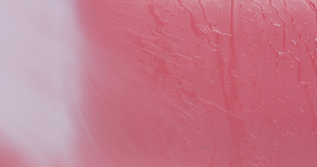 washing red car with pressure washer