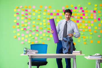 Man in the office with many conflicting priorities preparing go 