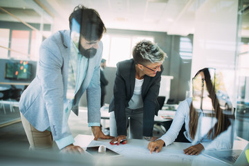 Team of architects working on construction plans