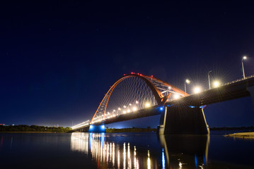 Fototapeta na wymiar Bridge over the river Ob night. The lights of the bridge glow in the night sky. 