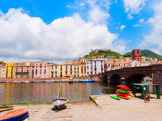 View of fishing boats and beautiful colorful houses in the city of Bosa. province of Oristano, Sardinia, Italy
