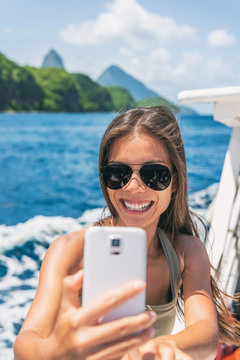 Cruise caribbean travel selfie tourist Asian girl on St Lucia Pitons mountains boat ride tour excursion. Summer sun holidays.