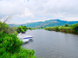 View of the river and fishing boats in the city of Bosa. province of Oristano, Sardinia, Italy.