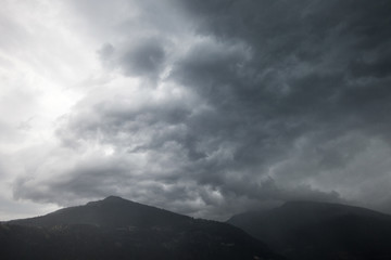 dark thunder clouds during rain storm in switzerland