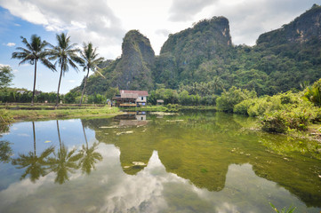 Fototapeta premium Beautiful limestones and water reflections in Rammang Rammang park near Makassar, South Sulawesi, Indonesia
