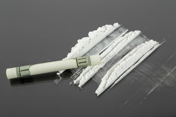 Lines of cocaine and one hundred dollar bill