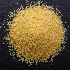 fresh couscous on a dark stone background