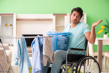 Disabled man on wheelchair doing laundry