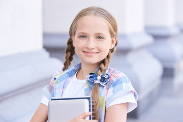 Youth schoolchild hug book. Enter school. Casual uniform