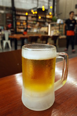 Glasses of light beer on a pub background