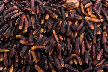 Background of the uncooked black rice close-up