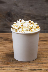 Salt popcorn on the wooden table,