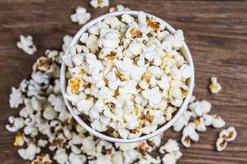 Salt popcorn on the wooden table,