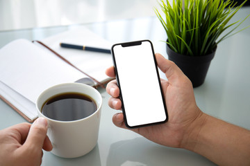man hand holding phone with isolated screen in office