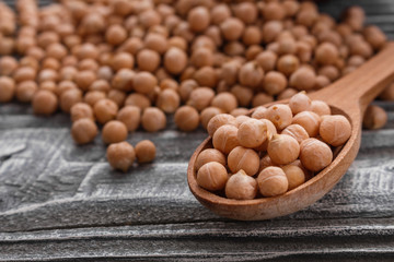 uncooked chickpeas on a wooden rustic background