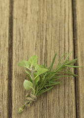 rosemary and oregano on wooden table