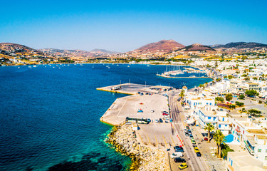 Breathtaking aerial view of the quay and shoreline of small seaside town at sunny day on Paros...