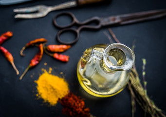 Colourful spices with oil on a black kitchen table