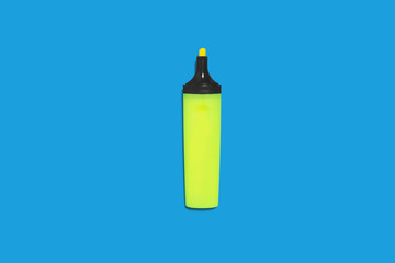 new green bright plastic marker lying on a blue background without a cap. concept of office supplies