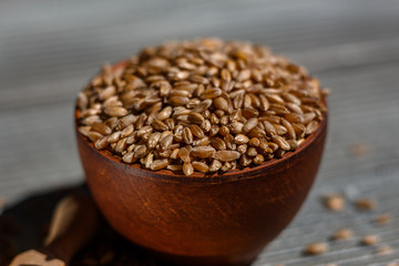 spelt seeds on a wooden rustic background