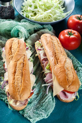 Submarine sandwiches with ham, cheese and vegetables